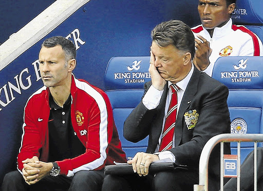 Manchester United manager Louis van Gaal shows the strain while his assistant, Ryan Giggs, watches glumly during United's 5-3 defeat at Leicester's King Power Stadium.