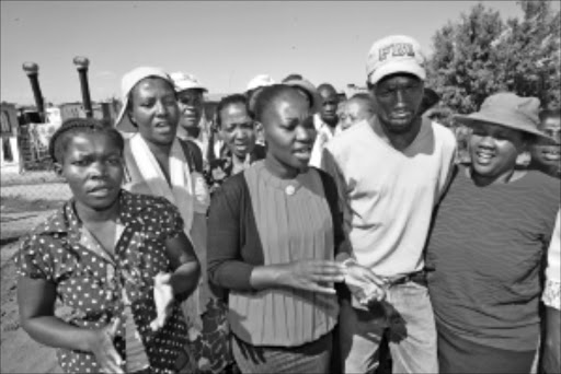 GOOD DEED: Gospel singer Fikile Mlomo, centre, has donated R5350 for the burial of Mantwa Sello at Lindelani Section in Ivory Park, in Thembisa. PIC: ANTONIO MUCHAVE. 09/02/29010. © Sowetan.