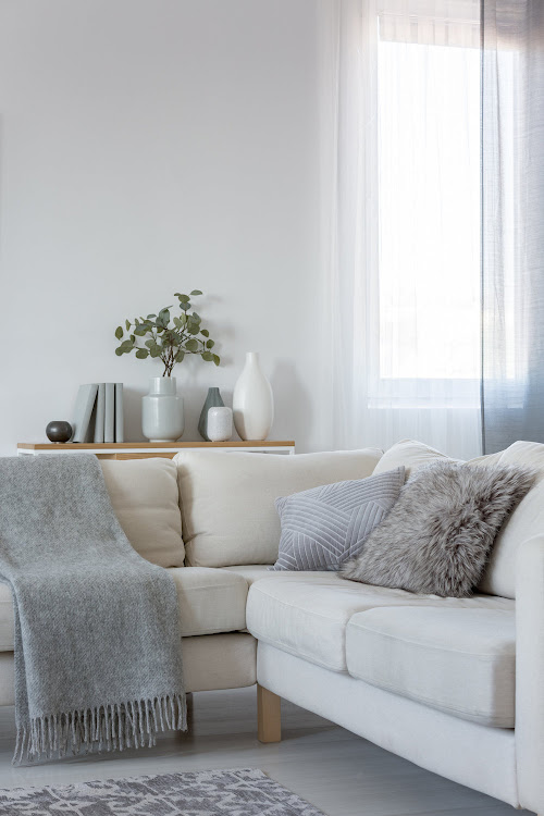 Corner sofa with pillows and blanket.