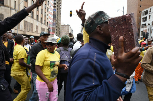 Luthuli House protesters arm themselves with bricks.