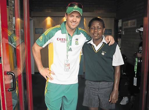 AB de Villiers and Wonder Nkosi take shelter after being caught in the rain at SuperSport Park in Centurion Picture: SIMON MATHEBULA