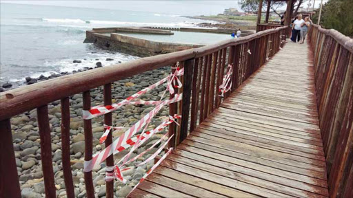 TOURIST TRAP: Gaping holes leading to a sheer drop onto the rocks below have been barred with hazard tape, but community members are furious about the lack of maintenance and one resident has vowed to close the Gonubie boardwalk because it is unsafe Picture: BARBARA HOLLANDS
