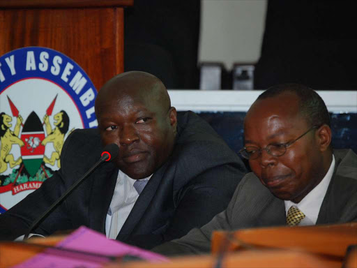 From left the chairman of Nakuru public service board Waithanji Mutiti and county account officer Jeph Mbugua during grilling at the county assembly last year./FILE