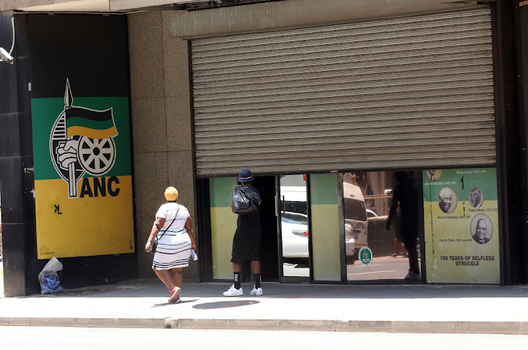 People walk past the ANC's headquarters, Luthuli House, in Johannesburg. Picture: VELI NHLAPO