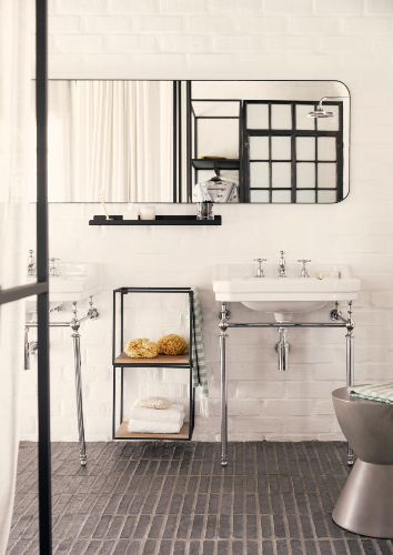 Stripped of superfluous design, glossy polished chrome legs support the simple porcelain basins. The pedestal sink balances the other features in the room without making the small space feel overdone or cramped.