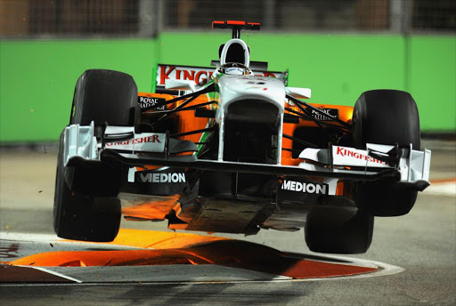 Adrian Sutil of Germany and Force India goes airborne as he hits a curb during practice for the Singapore Formula One Grand Prix at the Marina Bay Street Circuit on September 24, 2010 in Singapore