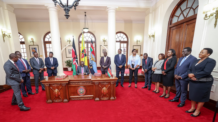 President William Ruto assenting to law two bills at State House, Nairobi as State officials witness on December 11, 2023