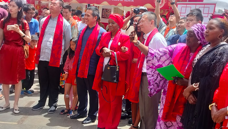 Director-General of the United Nations Office at Nairobi Zainab Hawa Bangura(in full red) and the Chinese Ambassador to Kenya Zhou Pingjian (white shirt) among other delegates during the 2024 Nairobi Chinese New Year Gala at Two Rivers Mall on February 10, 2024.