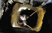 INTO THE DARK: A resident of Matholesville on the West Rand enters a disused mine shaft to search for missing miners