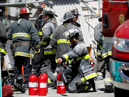 A firefighter works on a fire extinguisher outside a Pacific Gas and Electric (PG&E) substation after a fire broke out in San Francisco, California, US, April 21, 2017. /REUTERS