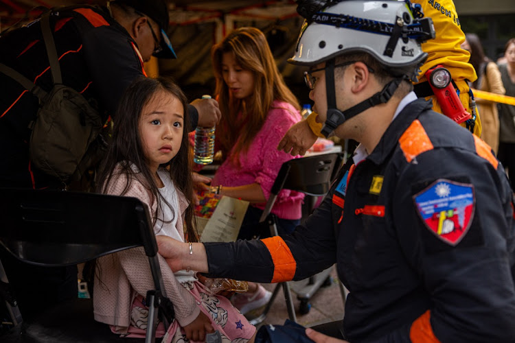 A child is given medical care at a temporary rescue command post outside of the Taroko Gorge after being rescued on April 05, 2024 in Hualien, Taiwan. There are still hundreds of victims stuck in the mountains after a 7.5 magnitude earthquake hit eastern Taiwan on Wednesday, April 3rd, triggering a tsunami warning for the coastline in Taiwan, The Philippines and Japan.