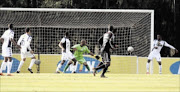 PUTTING IT IN: Orlando Pirates defender Siyabonga Sangweni, obscured, scores against Bidvest Wits at Bidvest Stadium in Johannesburg yesterday
       PHOTO: ANTONIO MUCHAVE