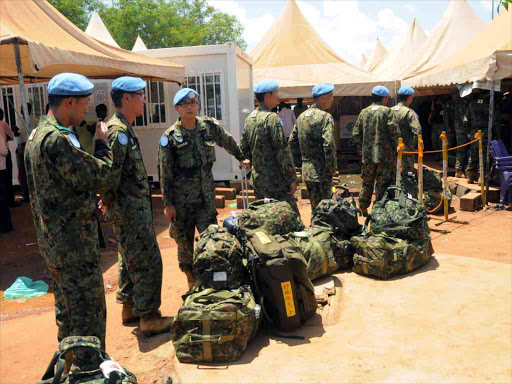 Japanese soldiers, part of the last group of Japanese soldiers from UNMISS, wait to board a plane at Juba International Airport in South Sudan May 25, 2017. /REUTERS