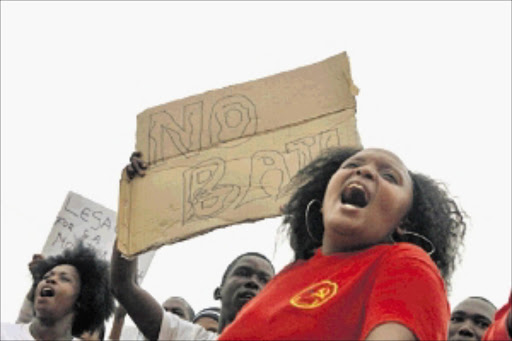 OUTRAGE: Protesters outside the Rustenburg magistrate's court make their point during the appearance of the five accused of the brutal slaying of entrepreneur Mirriam Khoza, 45, and her family. Pic. Bafana Mahlangu. 05/01/2010. © Sowetan. 20100105 BMA Protesters outside the Rustenburg magistrates' court making their point during the appearance of four men accused of killing a businesswoman and her family. PHOTO: BAFANA MAHLANGU