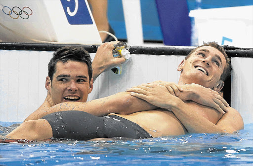 WORLD RECORD SMILE: Cameron van der Burgh, right, celebrates with Christian Sprenger of Australia after winning Olympic gold Picture: GETTY IMAGES
