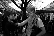 A woman wipes a tear from a relative after the Poppy Day memorial service. The day was attended by bikers from different crews.