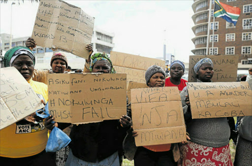 UP IN ARMS: Ward 13 residents protest outside City Hall yesterday against councillor Nokulunga Matiwane, who is out on bail after the killing of two EPWP workers in Reeston’s Dice Township two weeks ago