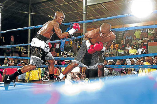 MASSIVE COMEBACK: Lusanda Komanisi and Aphiwe Mboyiya are seen here in a recent title fight at the Indoor Sports Centre in Mdantsane. Mboyiya will take on Russian Mikhail Alexeev on November 4 Picture: Picture: MARK ANDREWS