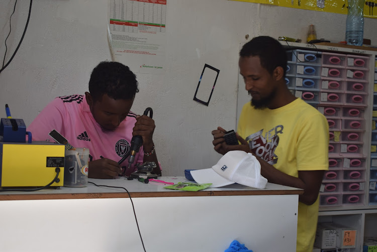 Ali Ibrahim at his phone repair shop in Isiolo