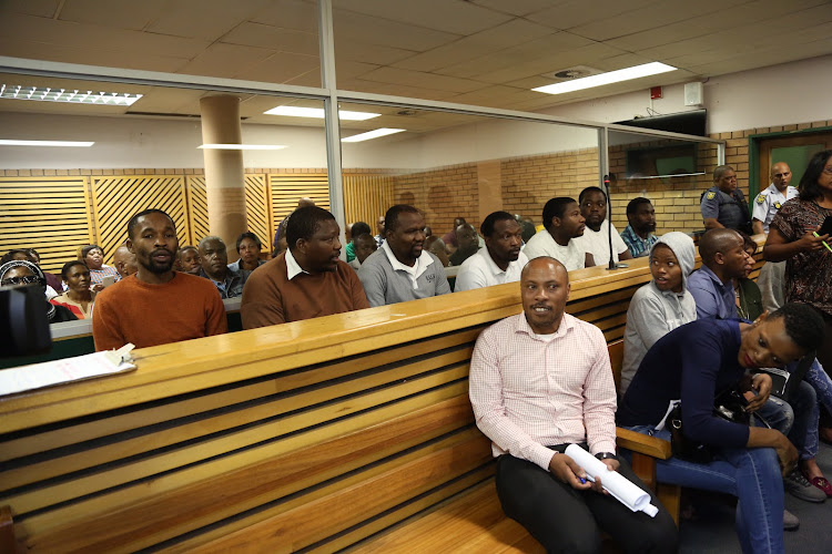 ANC councillor Nkosinathi Gambu (extreme left wearing an orange jersey) and his co-accused appeared in the PMB Regional court and six others on October 15 2018.