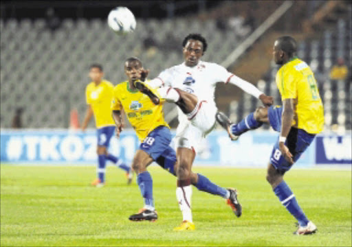 BIRDS NIGHT: Moroka Swallows striker Lerato Chabangu clears the ball from Mamelodi Sundowns' Hlompho Kekana and Wandisile Letlabika at Dobsonville Stadium in Soweto on Saturday evening. Photo: Gallo Images