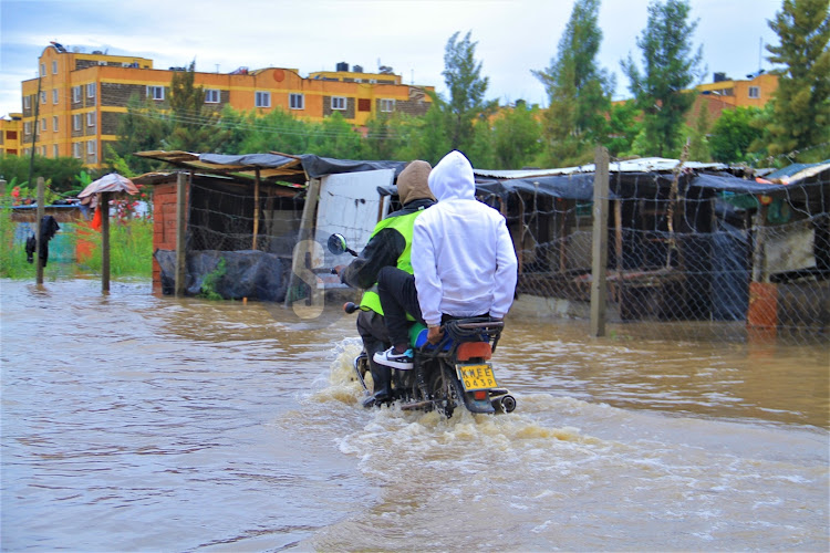 A boda boda rider along the flooded Syokimau-Katani road in Machakos County on Sunday, April 21, 2024.