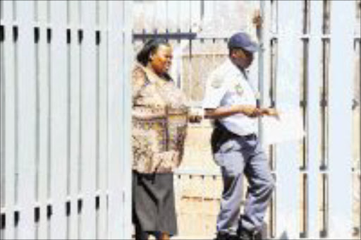 08 SEPTEMBER 2009 TUESDAY: NO HIDING: Inspector Frank Lebepe is escorting Patricia Mphahlele, ANC councillor in the Lepelle-Nkumpi Municipality in Limpopo who appeared briefly at Lebowakgomo Magistrate court for allegedly hiring four hitmen to kill her ex-boyfriend. PHOTO: ELIJAR MUSHIANA