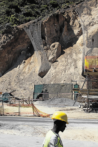 A worker at the section of quarry which collapsed on Chapman's Peak Picture: SHELLEY CHRISTIANS