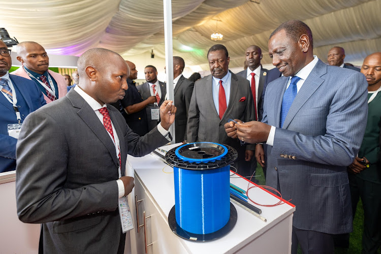 President William Ruto being taken through an exhibition at Uhuru Gardens, Nairobi during the opening of Connected Africa Summit 2024 on April 22, 2024.