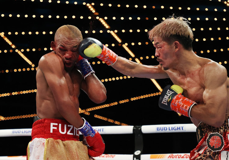 Kenichi Ogawa punches Azinga Fuzile during their championship bout for the vacant IBF junior lightweight title at The Hulu Theater at Madison Square Garden.