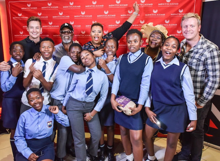 This is what dreams are made of: Anele Mdoda, John Kani and Connie Chiume with underprivileged children at a screening of Black Panther.