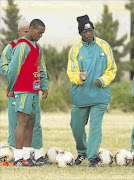 MASTERMIND: Former Bafana Bafana coach April 'Styles' Phumo explains tactics to Teboho Mokoena and Stanton Fredericks during a training session.
    
      Photo: Backpagepix