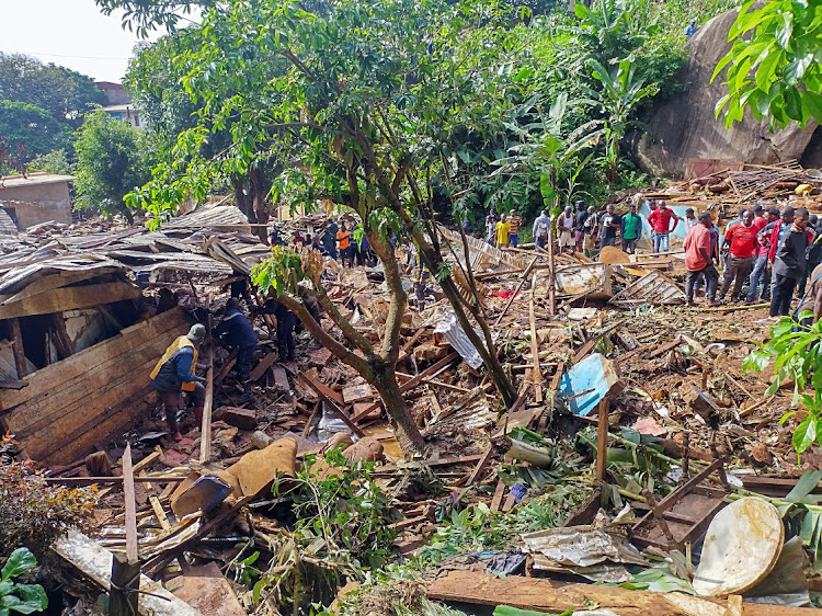 Rescuers search for bodies and survivors after a dam collapsed causing flooding, destroying homes and killing dozens in Yaounde, Cameroon on October 9 2023.