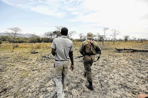 BOOTS: SANParks rangers scour the terrain in search of poachers' spoor. Poachers are decimating the rhino population of the Kruger National Park. File photo
