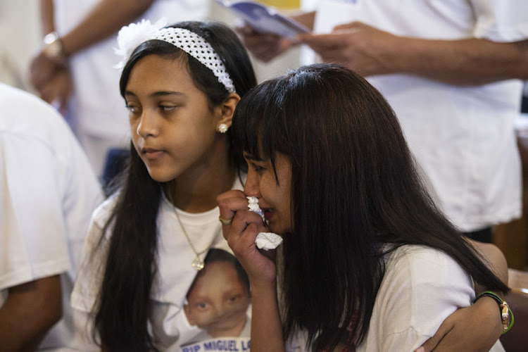 Raylene Louw held by her daughter Mikayla as they say their final goodbye to Miguel Louw at his funeral in Durban.