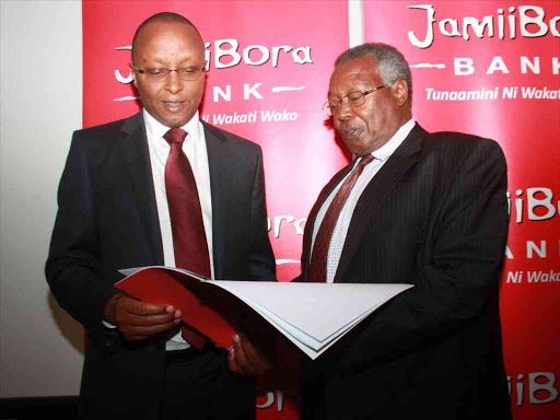 Jamii Bora Bank CEO Samuel Kimani with the group chairman James Gacheru during the bank annual general meeting at Jacaranda hotel in Nairobi on June 30 / FILE