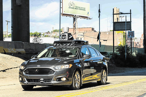 LOOK MA, NO HANDS: A passenger rides in a pilot model of an Uber self-driving car in Pittsburgh, Pennsylvania. Yesterday Uber launched the groundbreaking driverless car service, stealing ahead of Detroit car giants and Silicon Valley rivals
