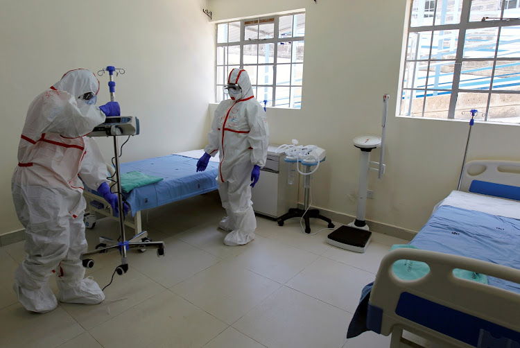 Kenyan nurses wearing protective gear prepare a ward during a demonstration of preparations for any potential coronavirus cases at the Mbagathi Hospital, isolation centre in Nairob in 2020