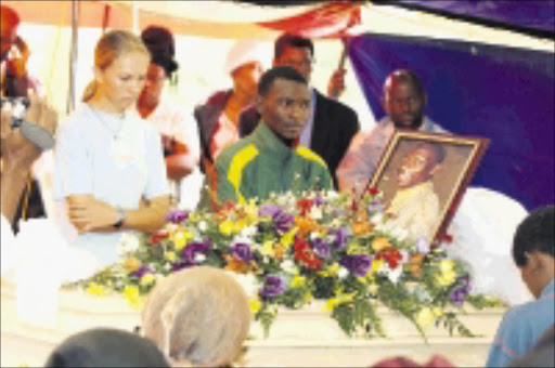 IN SHOCK: Family members and friends grive at the funeral of Freddy Sebona, who was allegedly stabbed to death by his daughter in Majakaneng, Brits. 11/01/2009. Pic. Bafana Mahlangu. © Sowetan.