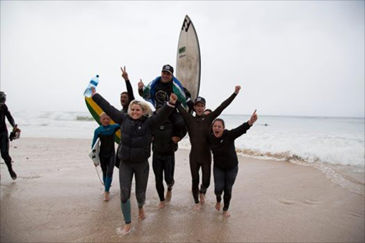 Marathon man: Eastern Cape surfer Josh Enslin is shouldered off the beach by friends and family after breaking the Guinness World Record for the longest surf session Picture :Sandy Smyth Coffey