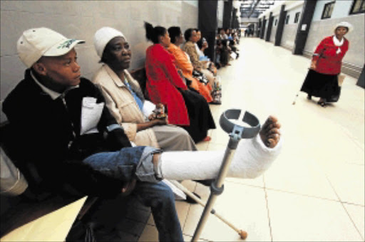 Seabelo Modikwe queues at the pharmacy at Chris Hani-Baragwanath Hospital after a cast was put on his broken leg Picture: MARIANNE SCHWANKHART