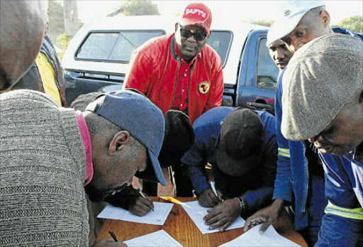 NEW START: South African Federation of Trade Unions general secretary Zwelinzima Vavi watches as 50 ex- Samwu members sign forms joining his newly established union in East London. picture: BHONGO JACOB