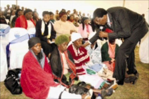 MOURNING: KwaZulu-Natal MEC for social development Meshack Radebe comfort the relatives. Pic. Thuli Dlamini. © Sowetan.