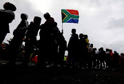 Residents of Siqalo informal settlement queue to vote in Mitchells Plain, Cape Town. 