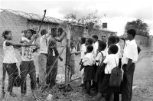 LOCKED OUT: Pupils at Doornlaagte Combined School, Zeerust. 15/01/2009. Pic. Peter Mogaki. © Sowetan.