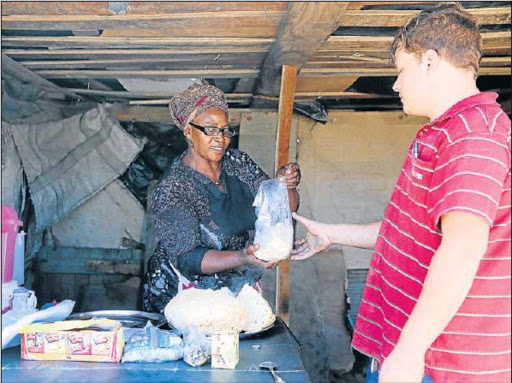 Zoliswa Simandla, an informal business owner in Fort Jackson, helps her customer Jaundre Olivier. Picture: SIBONGILE NGALWA