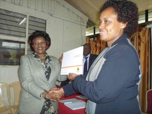 Machakos woman representative candidate Agnes Kavindu receives her nomination certificate from Jubilee Party regional coordinator Susan Maina on May 15, 2017. /ANDREW MBUVA