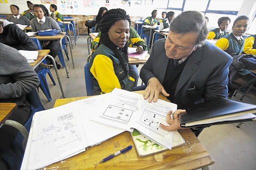 CLASS ACT: Western Cape education MEC Donald Grant with Ongezwa Kulati, of Langa High School, at a spring school class at Alexander Sinton High School, Athlone Picture: HALDEN KROG