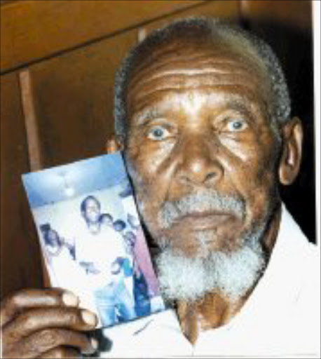 KICKER: Jack Modise, 91, holds a picture of his grandson, Papi Mokubung, who commited suicide by hanging himself with an electrical wire. Pic. Len Kumalo. 01/01/2008. © Sowetan.