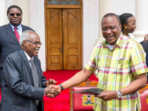 President Uhuru Kenyatta is presented with the road map for Kenya’s second assessment by the African Peer Review Mechanism (APRM) Panel of Eminent Persons, at State House in Nairobi, August 20, 2016. /PSCU